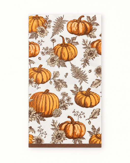 A rectangular kitchen towel or napkin with an autumn pattern of orange pumpkins, brown leaves, and sunflowers on a cream background, finished with a brown border.