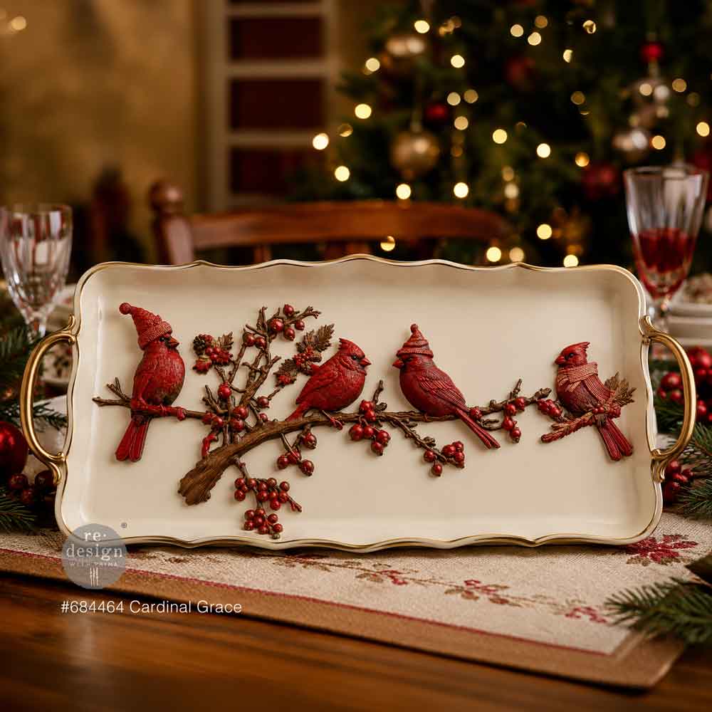 Decorative tray with red cardinal design on a festive table setting.