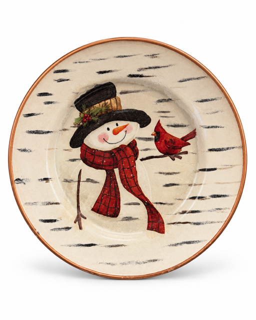 A round ceramic plate with a winter holiday design, featuring a hand-painted snowman in a black top hat and red plaid scarf next to a red cardinal, on a white background.
