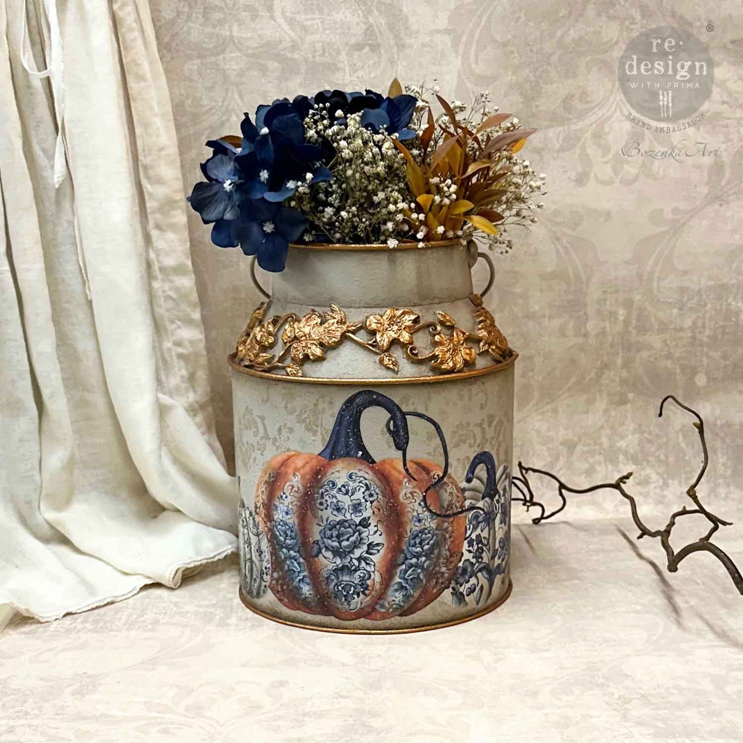 a close up of the milk can vase with a floral arrangement and one of the transfer pumpkin chinoiserie image on the front.