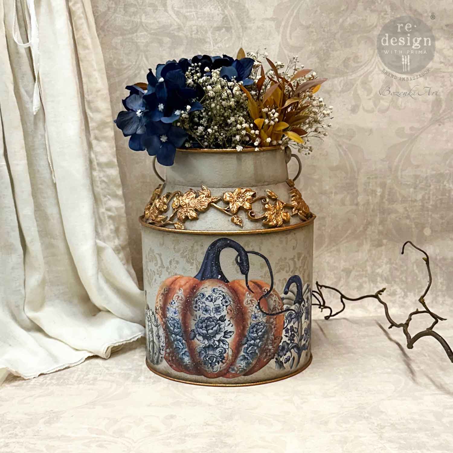 a close up of the milk can vase with a floral arrangement and one of the transfer pumpkin chinoiserie image on the front.