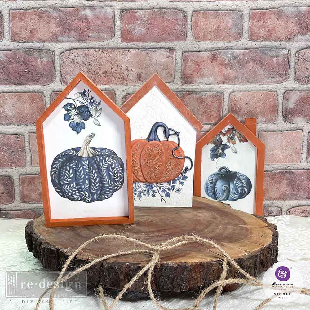 wood house shape cutouts with images of the pumpkin chinoiserie transfer on each of them.