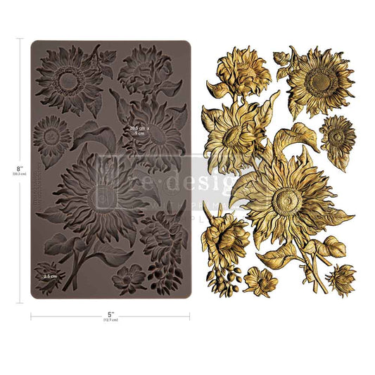 Decorative sunflower mold and gold sunflower embellishments on a white background