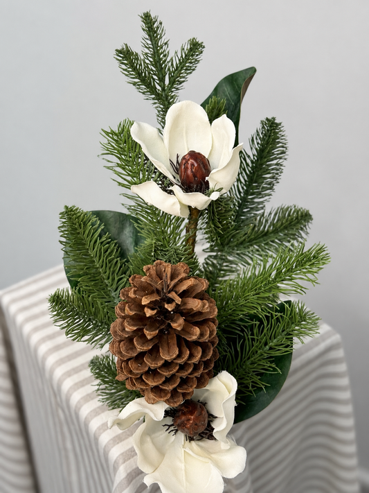 Magnolia pick with real feel pine branches, magnolia leaves, magnolia blooms, and pinecone.
