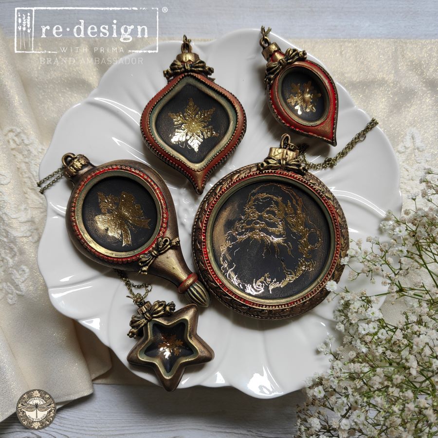 Decorative necklaces with vintage-style portraits on a white dish with flowers.