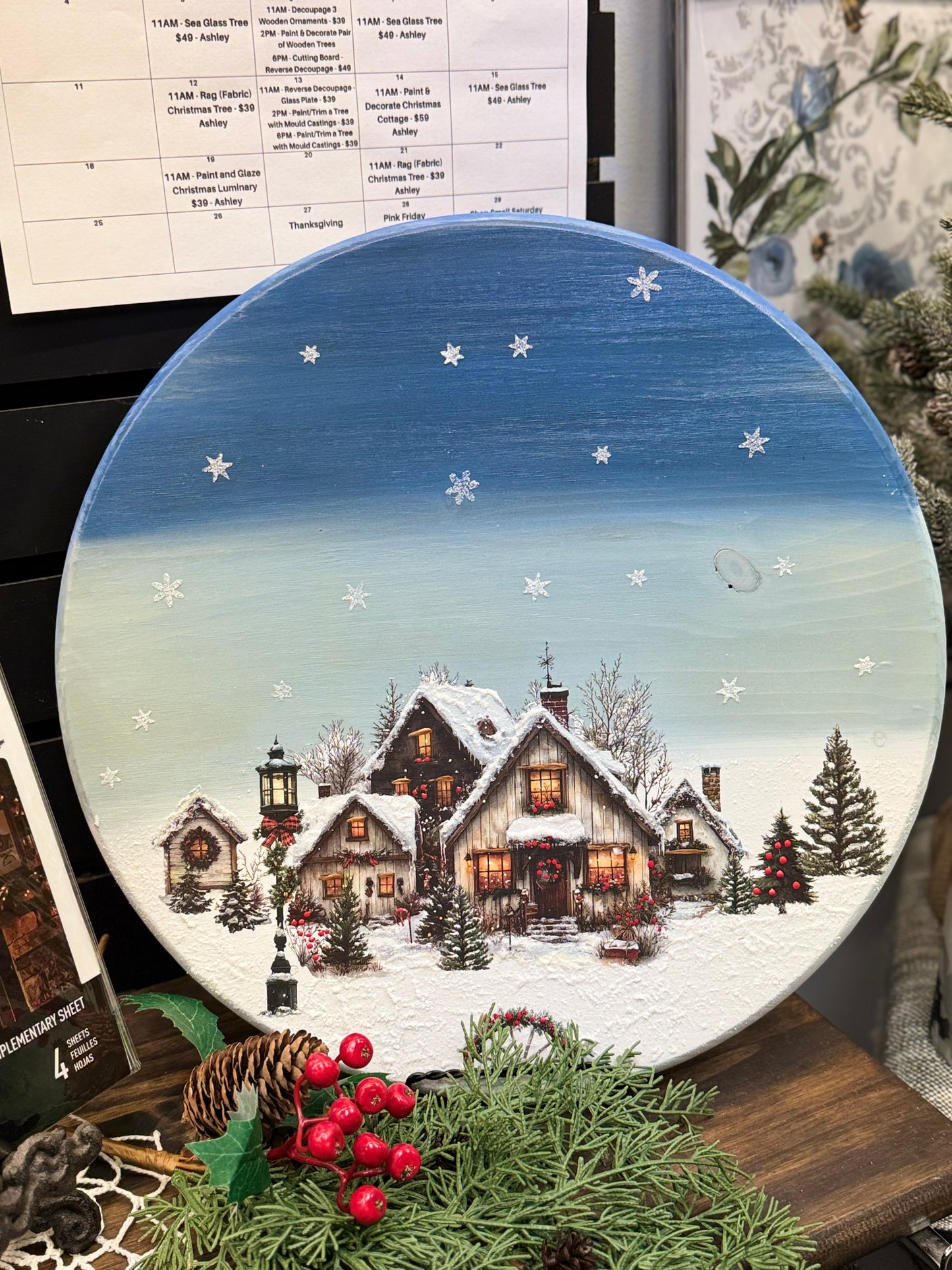 Frosted rooftops, glowing windows, and snow-dusted trees, Village of Wonder Middy Transfers® captures the magic of a holiday town just waiting to come to life. Each sheet is filled with charming cottages, cozy lanterns, pinecones, wreaths, and snowy shopfronts, all illustrated with storybook warmth and incredible detail. Perfect for creating winter scenes on furniture, signs, framed art, and more. HOW TO USE: Rub the Village of Wonder Middy Transfer onto any clean surface to create your own little Christmas