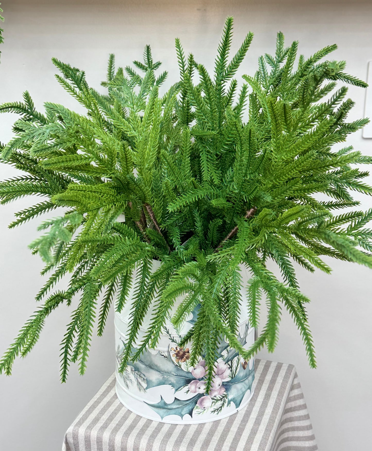 a vase full of 20" Norfolk Pine Greenery Picks.