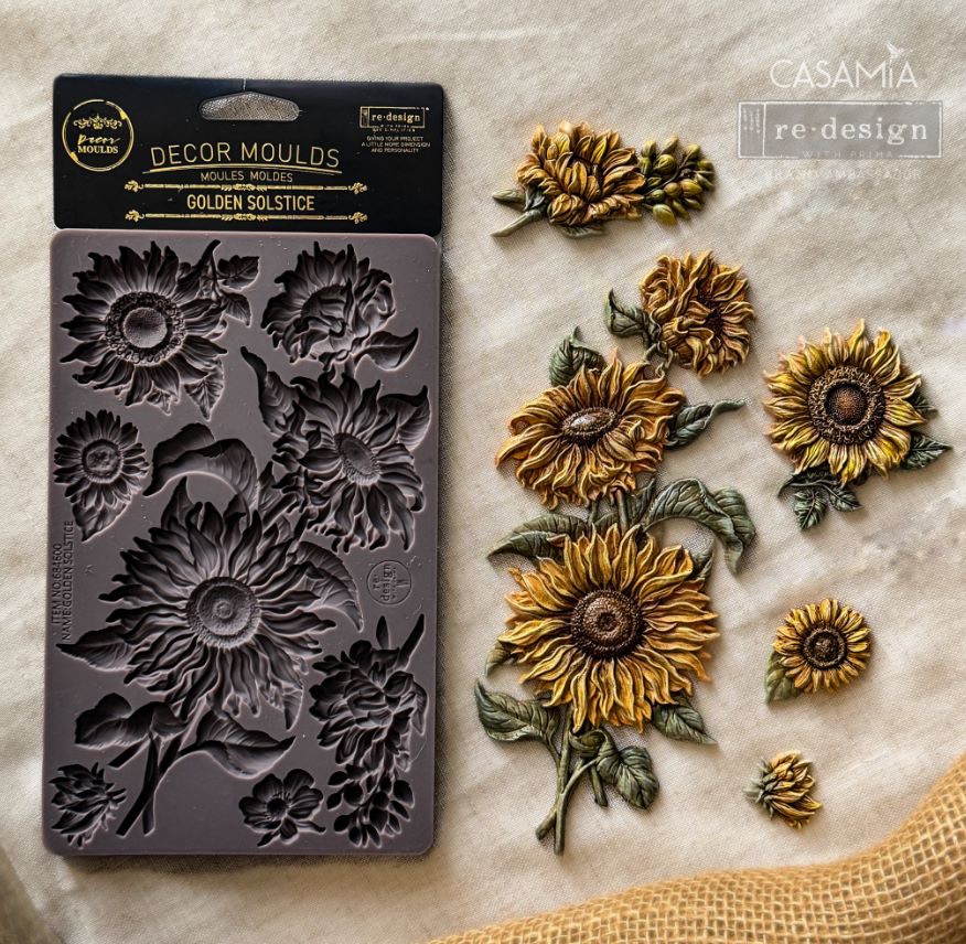 Decorative sunflower mold and finished sunflower decorations on a marble surface with 'Casamia' branding.