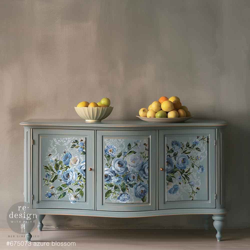 Decorative sideboard with floral designs on doors against a plain wall.