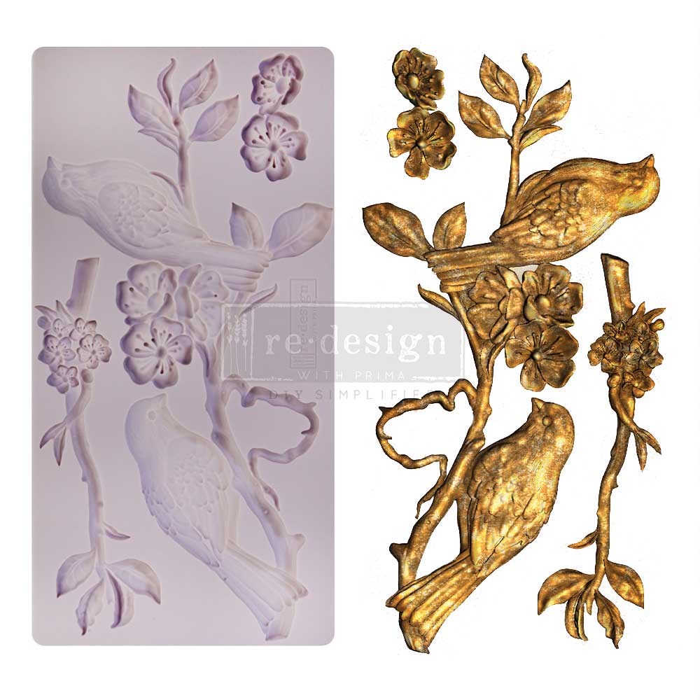 Decorative mold for creating floral and bird designs, with a gold finished product on the right.