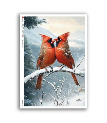 Two red cardinals on a snowy branch with a winter landscape background