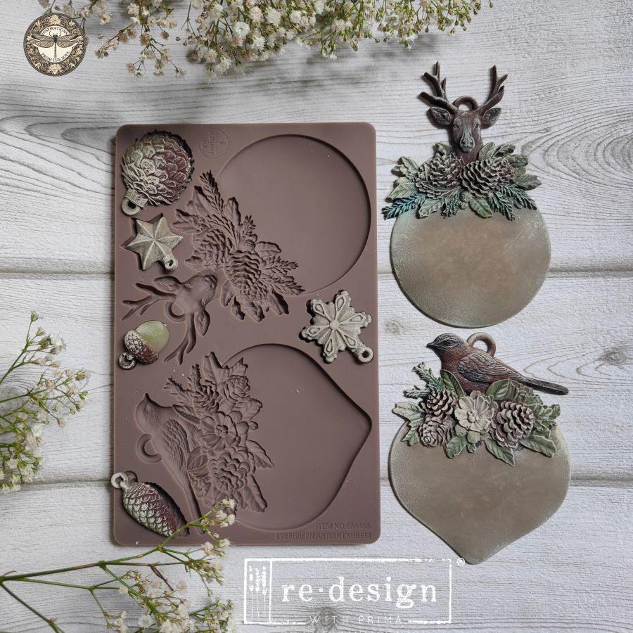 Silicone mold with nature-themed designs and a finished product on a wooden surface, featuring the 're-design' brand.