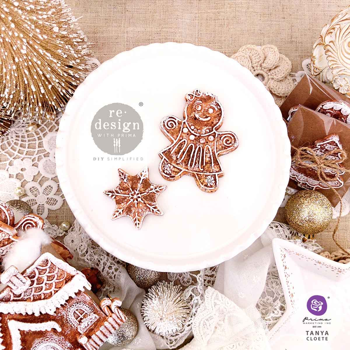 Decorative stamp set with gingerbread design on a textured surface with Christmas decorations.