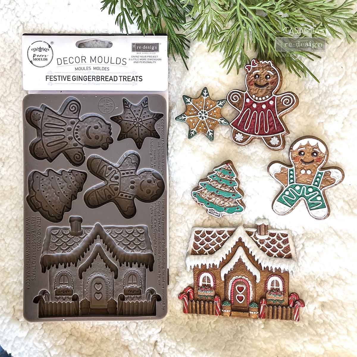 Decorative mold for gingerbread treats with gingerbread men, houses, and trees on a white background.