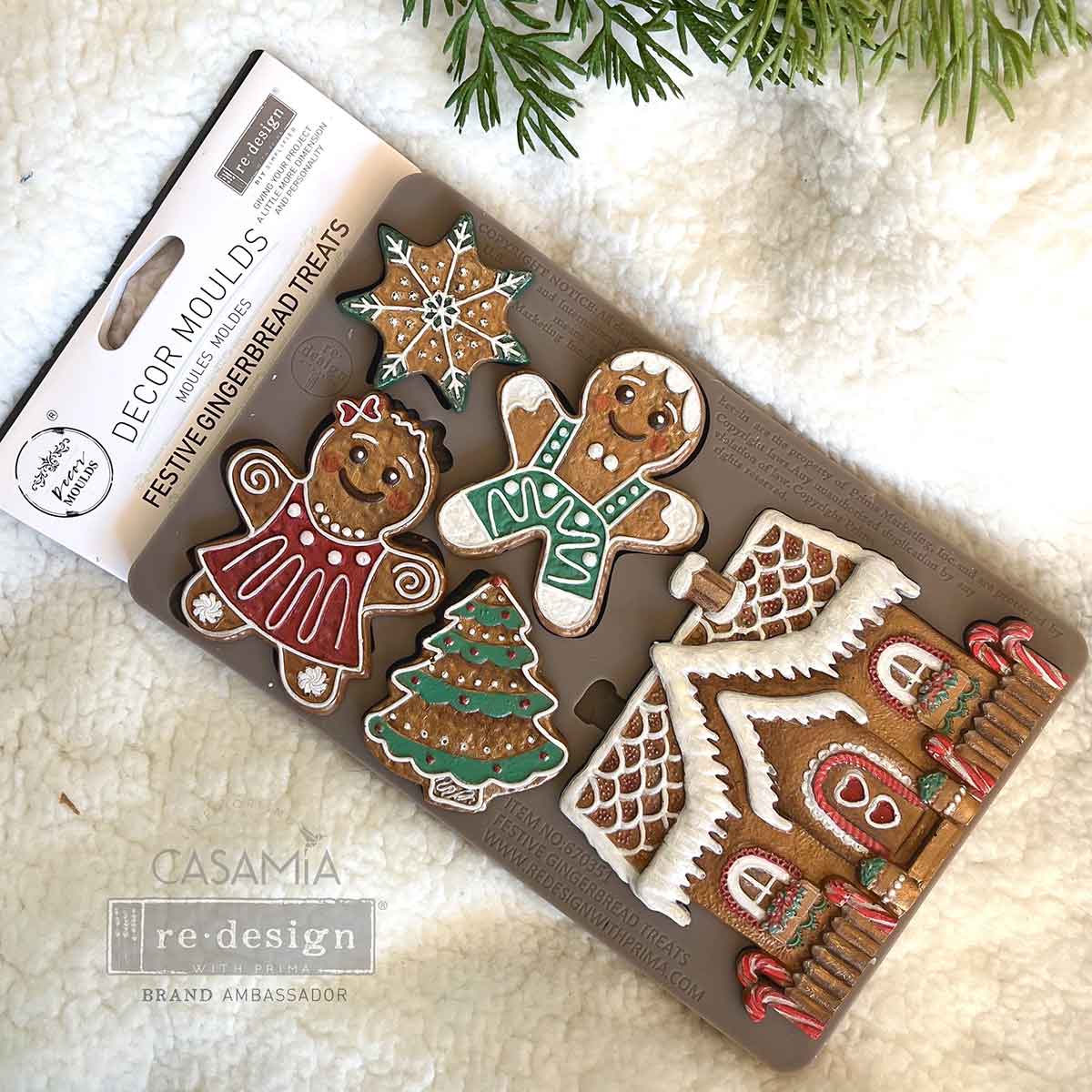 Decorative gingerbread mold set with Christmas-themed designs on a white surface.