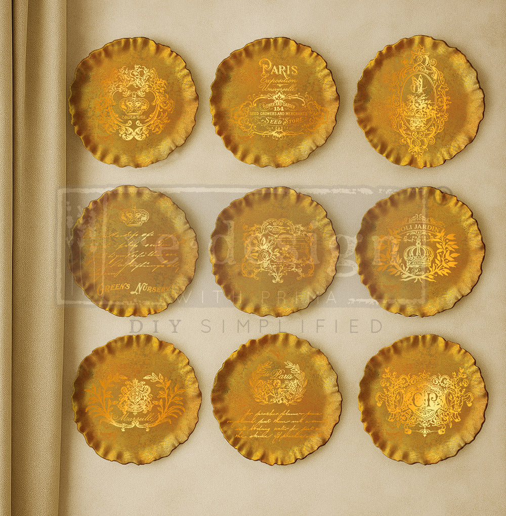 Set of gold decorative plates with intricate designs on a beige background