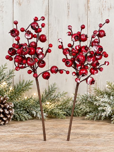 Two 13 inch artificial red berry Christmas picks with snow dusted berries displayed against a rustic holiday background.