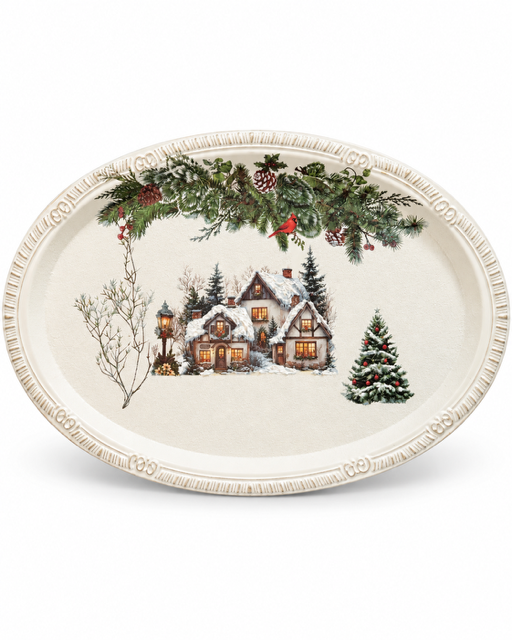 An oval ceramic serving platter featuring a festive winter village scene with a snow-covered house, evergreen trees, pinecones, and a bird perched on a garland, on a white background.