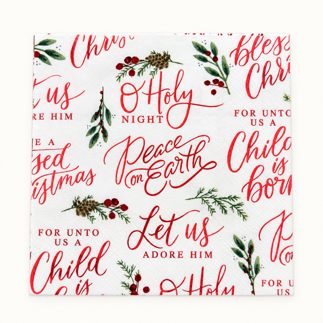 A square white paper napkin with a festive Christmas print featuring red script text, green holly leaves, pinecones, and red berries, photographed flat against a light neutral background.