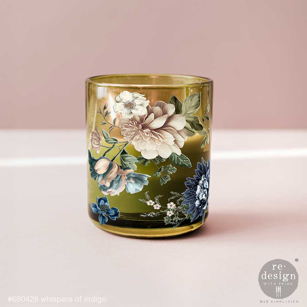 Decorative glass candle holder with floral design on a pink background