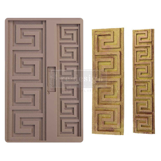 Decorative mold with Greek key pattern and two wooden samples on a white background