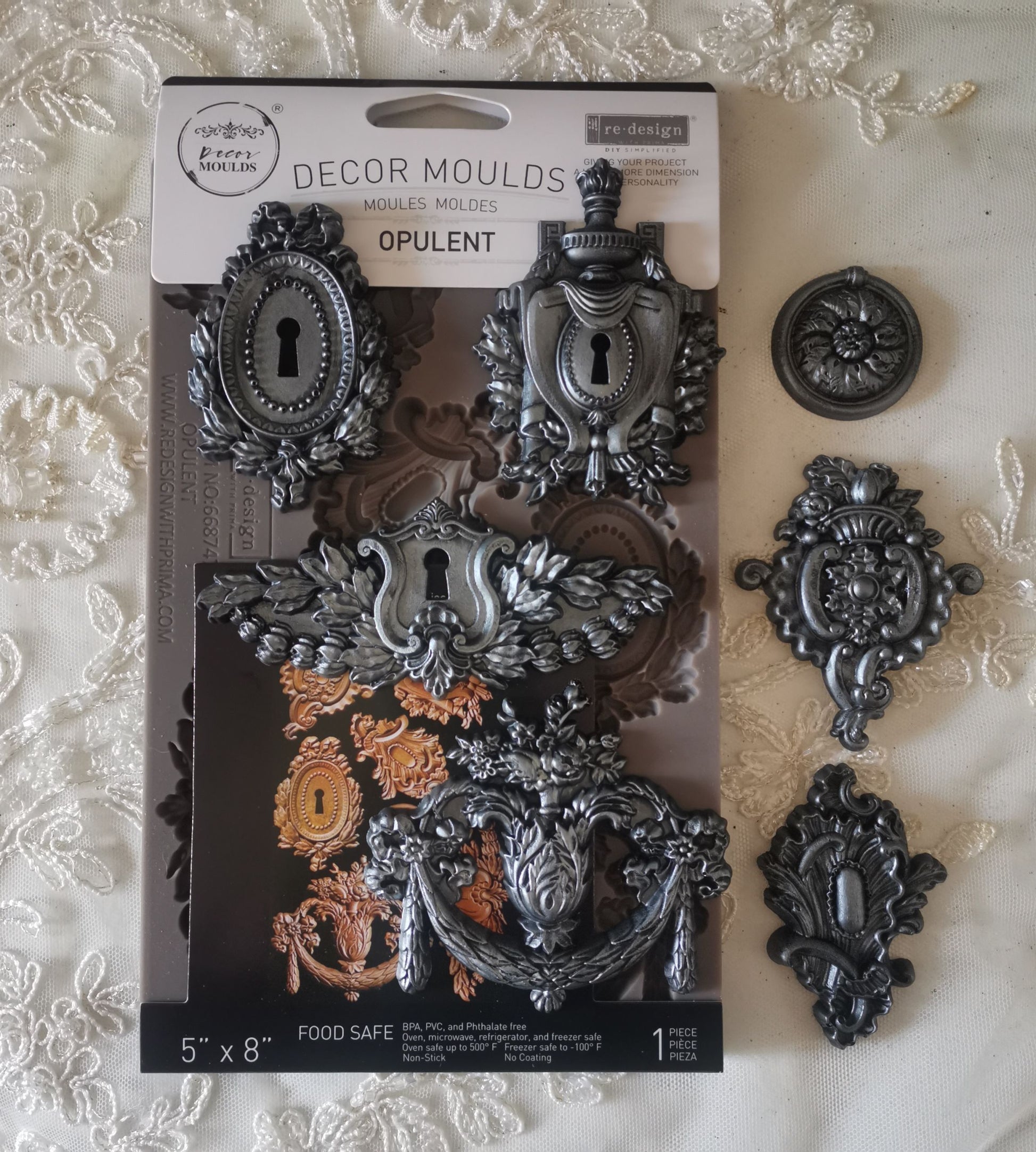 Decorative mold packaging with metal decor pieces on a textured surface