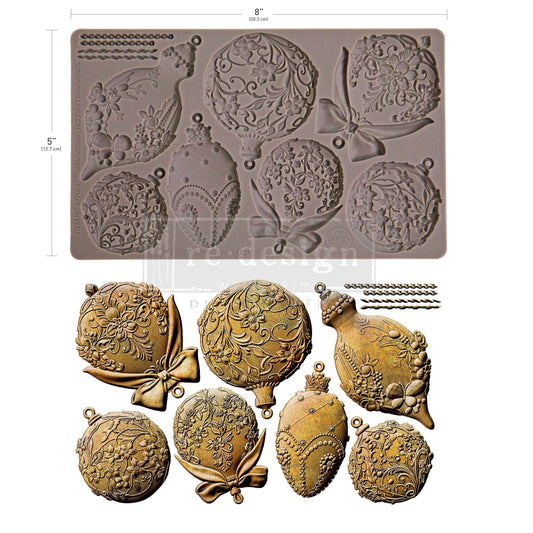 Decorative mold with intricate designs and gold-colored embossed items on a white background.