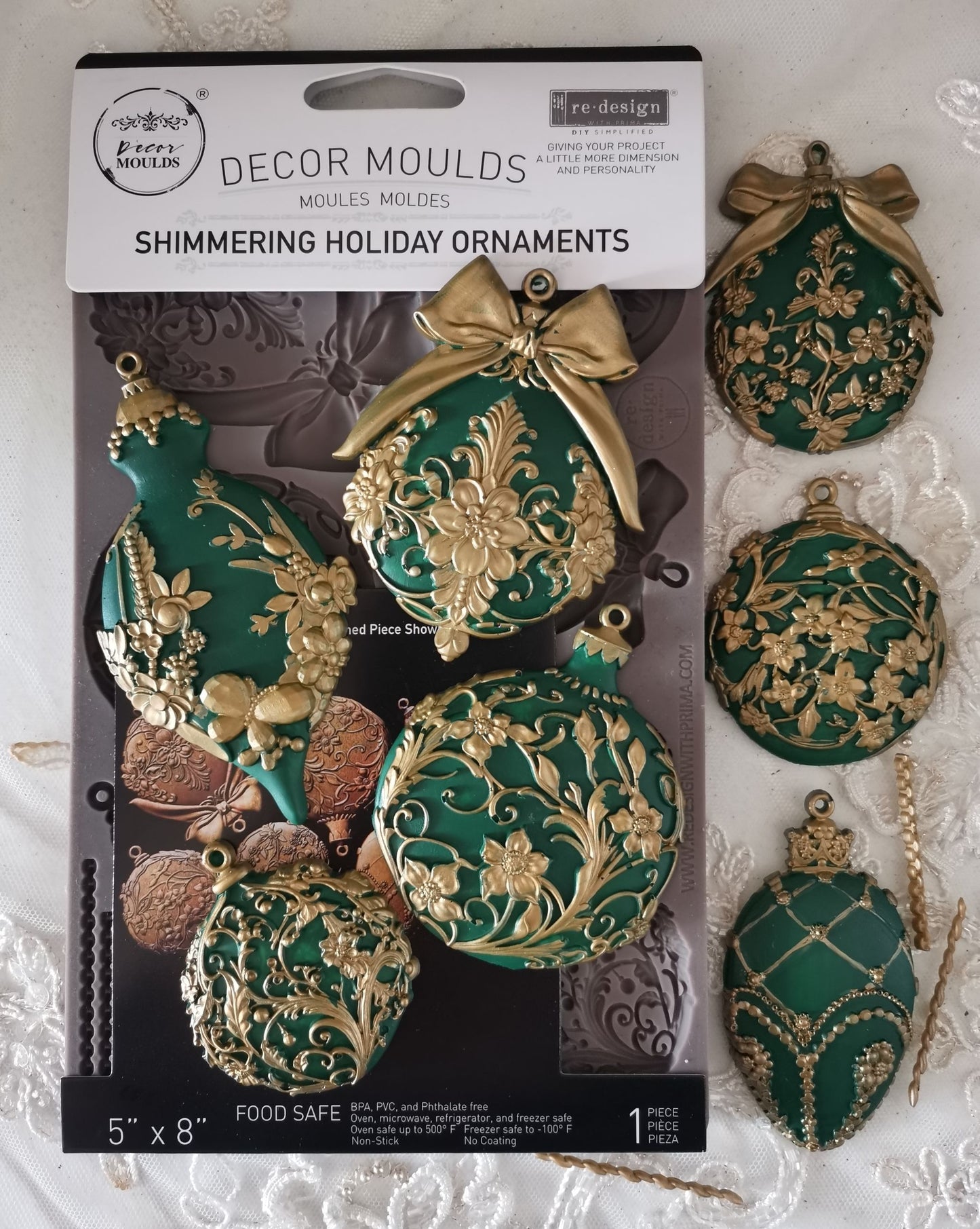 Decorative moulds for making shimmery holiday ornaments in green and gold packaging.