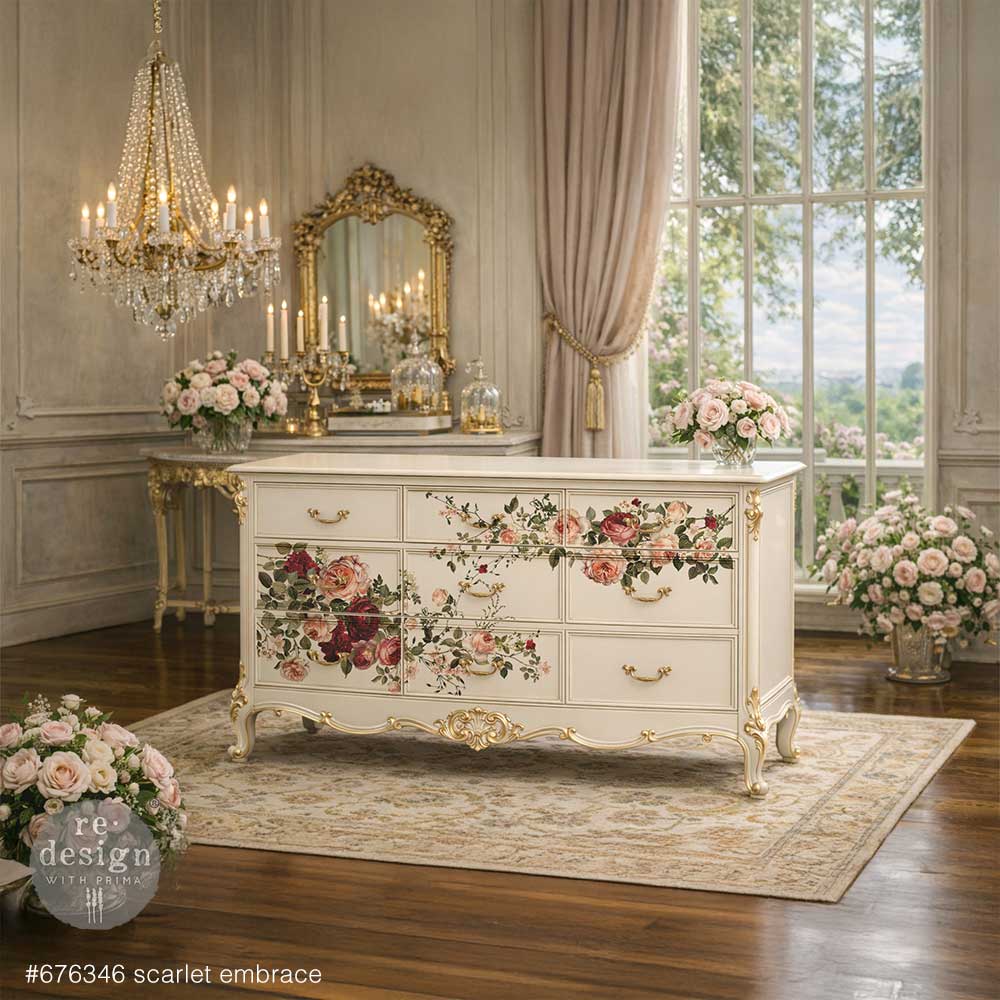 Rich, romantic, and undeniably captivating, Scarlet Embrace features a lush arrangement of blooming roses in deep crimson, soft blush, and warm ivory tones. With its graceful composition and painterly detail, this design evokes timeless elegance—perfect for adding a bold yet refined floral statement to any piece. transfer on a ornate long white dresser