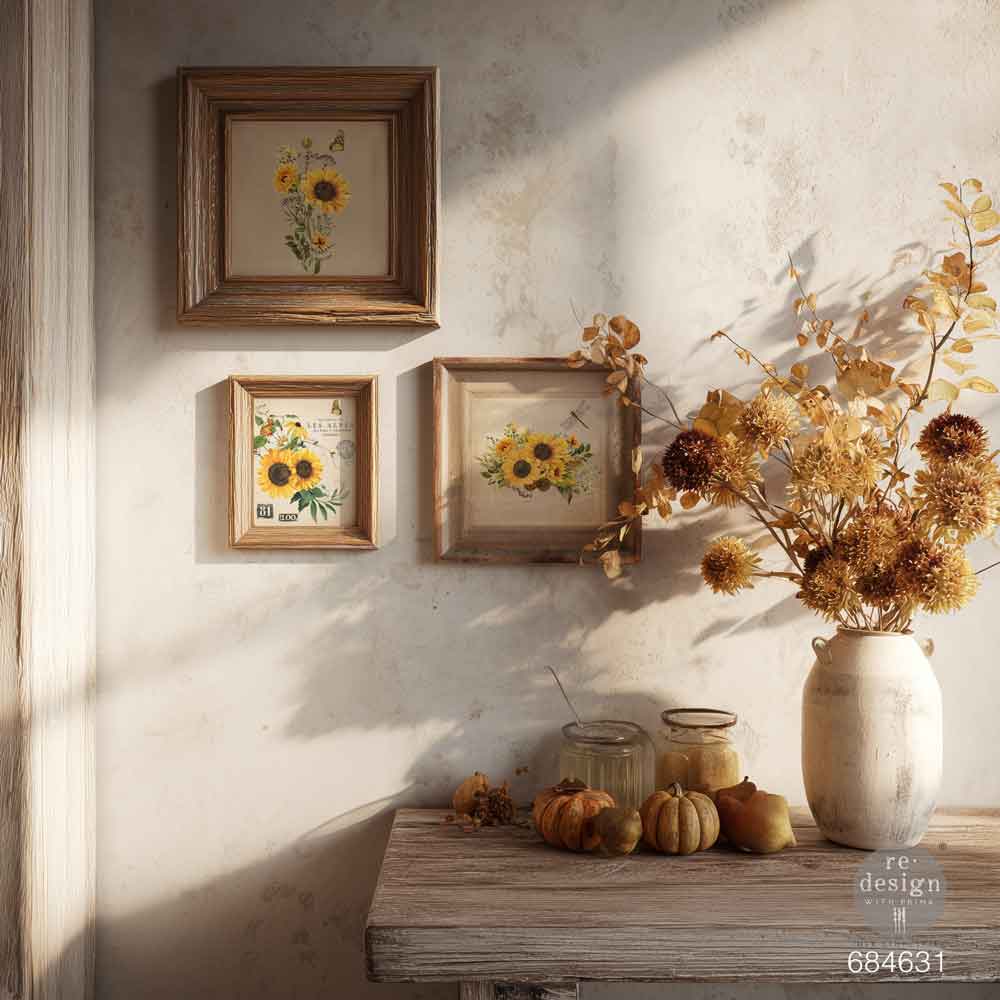 Decorative setting with framed sunflower prints and a vase of flowers on a wooden table.